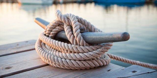 Dock cleat with boats at marina